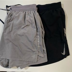 Grey and Black pair of Nike running shorts
